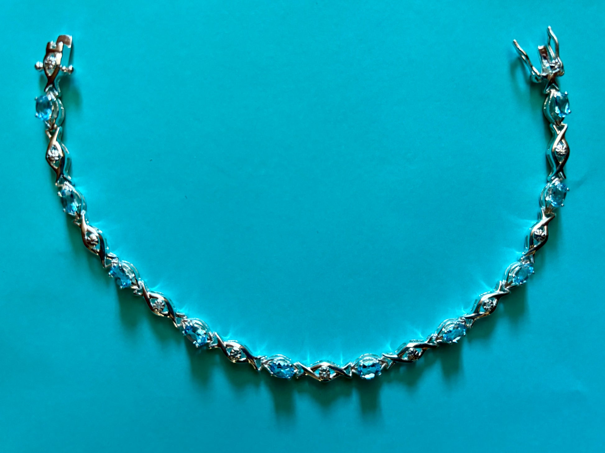 Sterling silver blue topaz bracelet from the Enchanted Crystals Collection featuring delicate light blue stones.