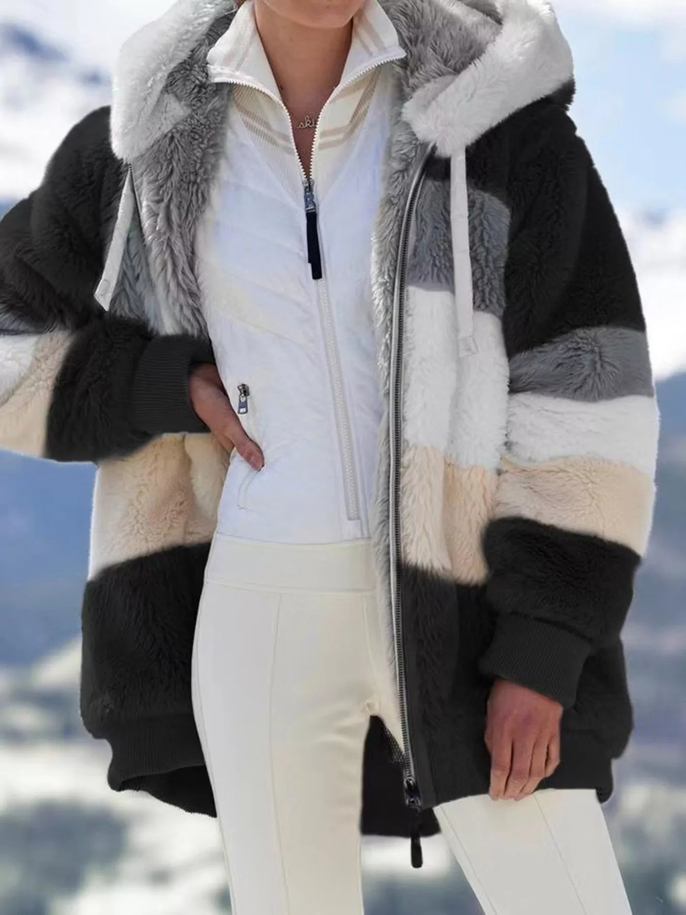 Soft plush faux fur zip jacket with drawstring hood and pockets.