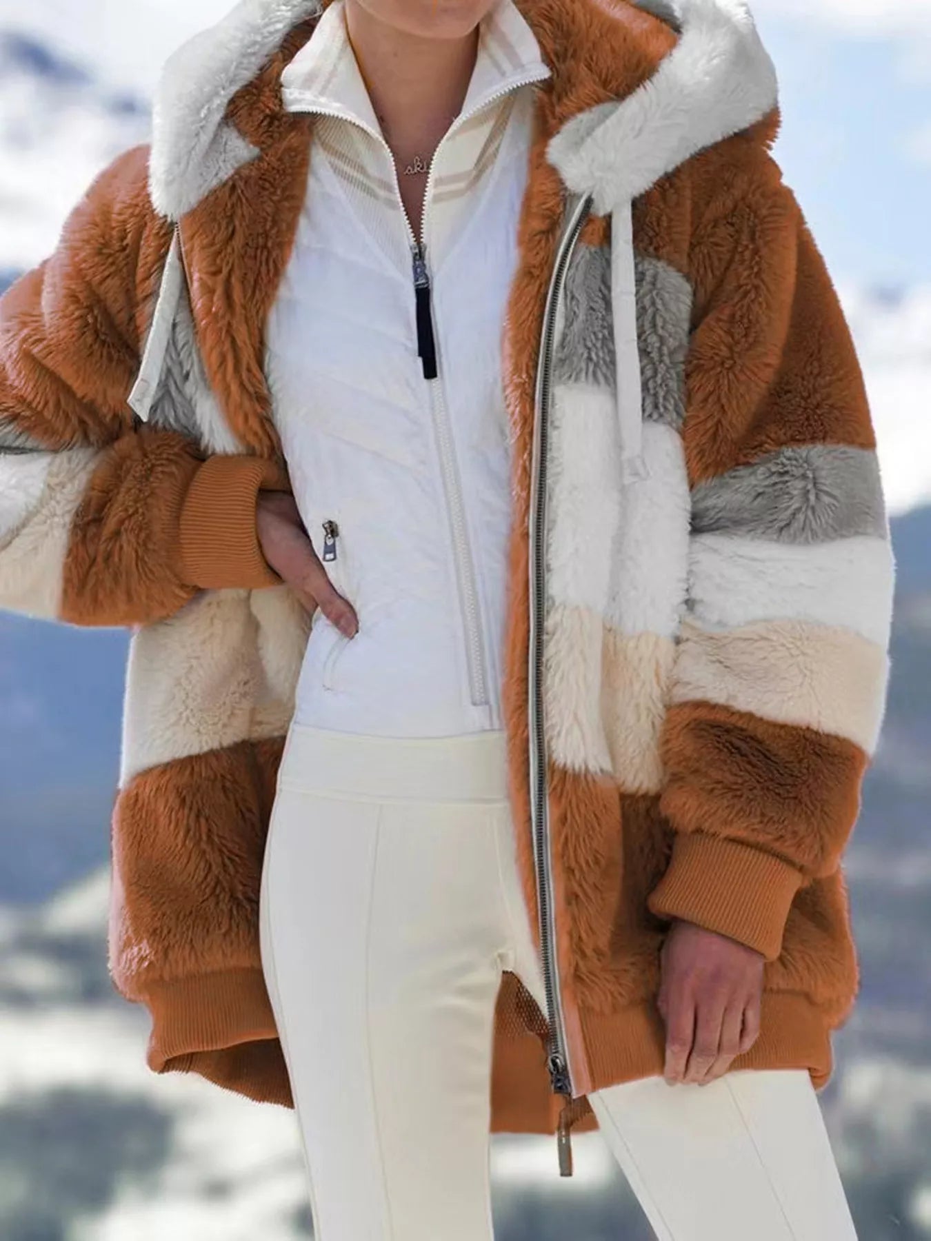 Soft plush faux fur zip jacket with drawstring hood and pockets.