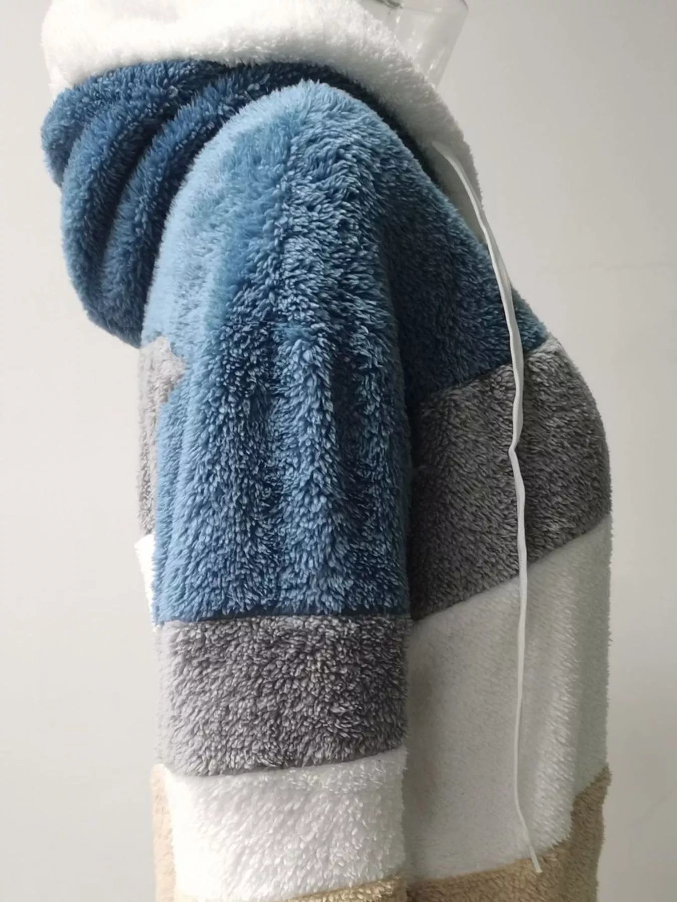 Soft plush faux fur zip jacket with drawstring hood and pockets.