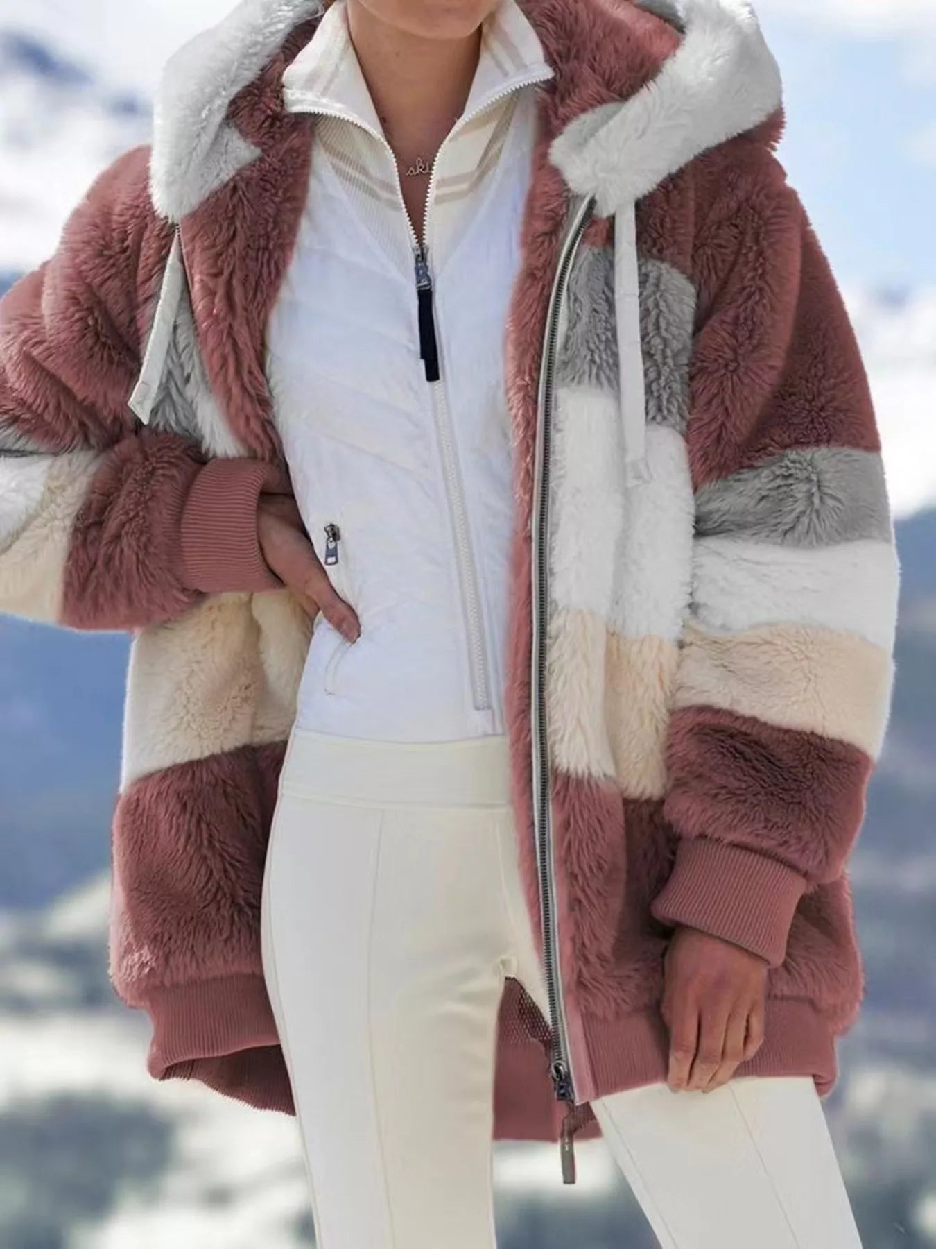 Soft plush faux fur zip jacket with drawstring hood and pockets.