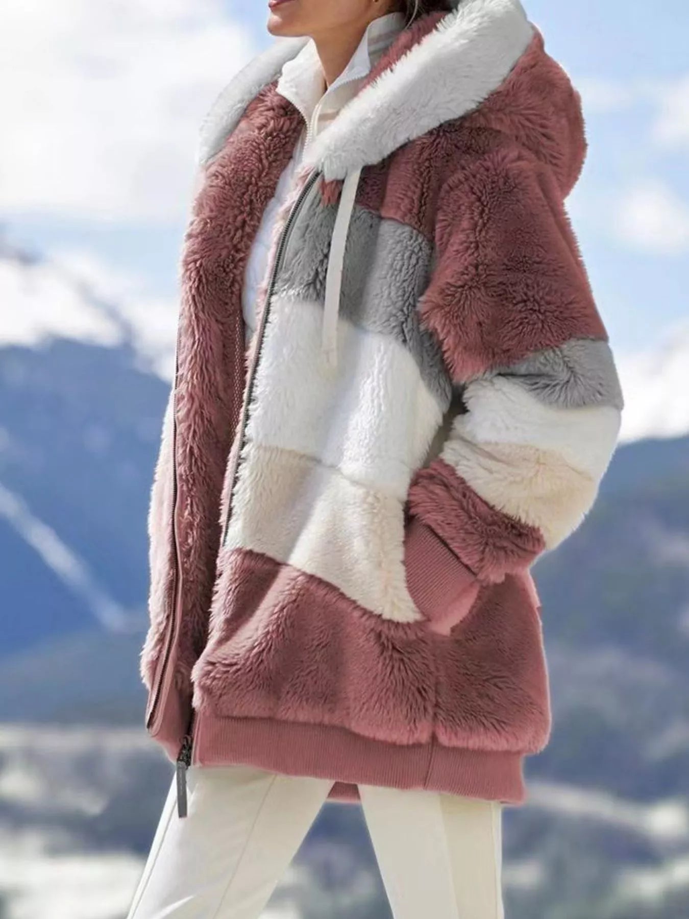 Soft plush faux fur zip jacket with drawstring hood and pockets.