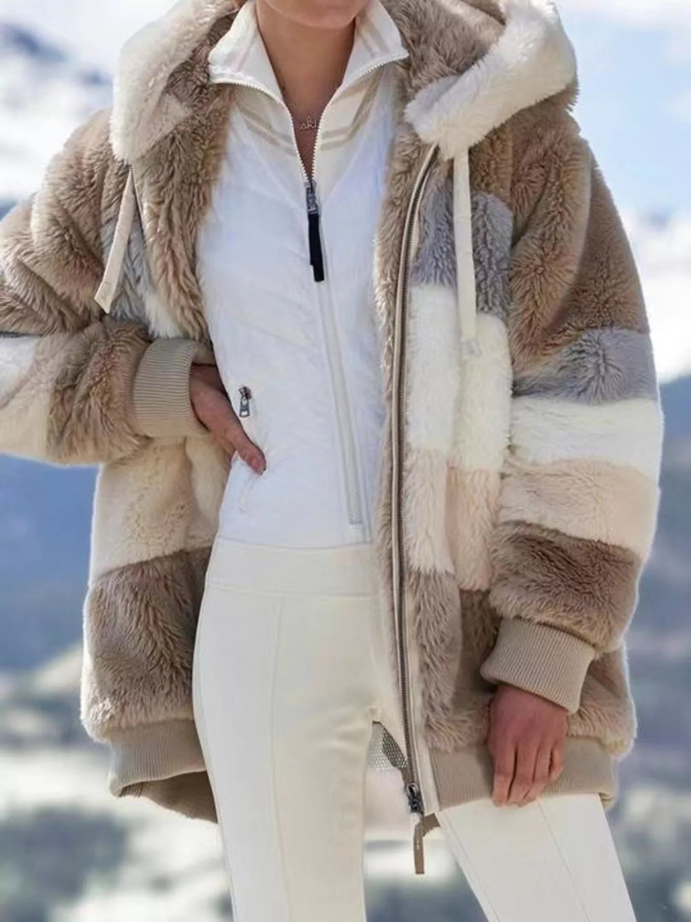 Soft plush faux fur zip jacket with drawstring hood and pockets.