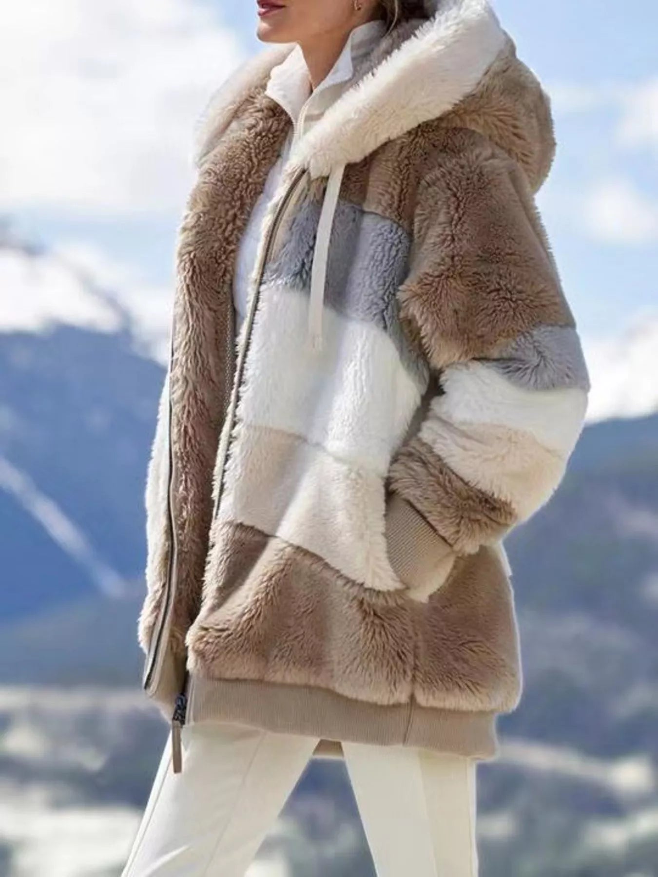 Soft plush faux fur zip jacket with drawstring hood and pockets.