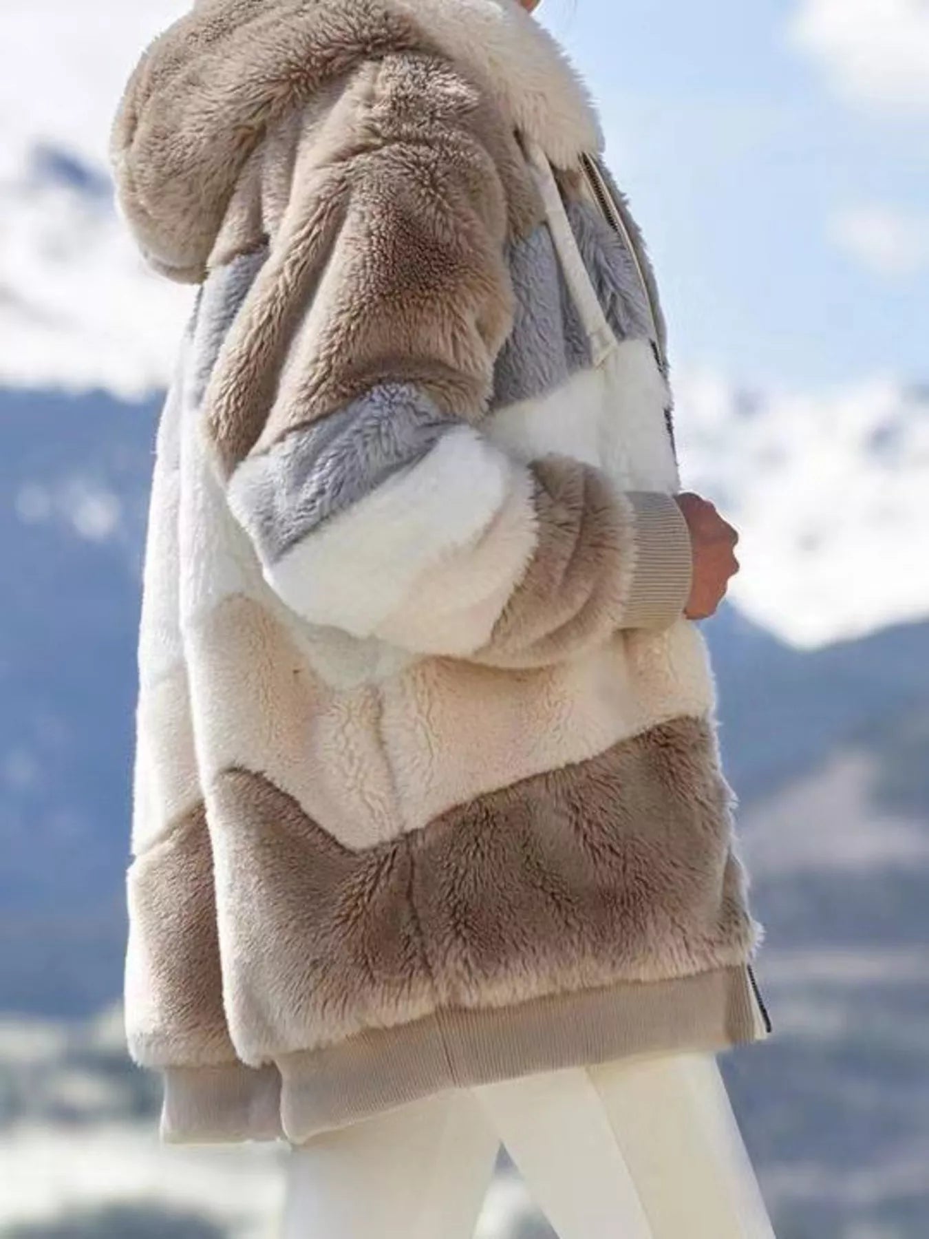Soft plush faux fur zip jacket with drawstring hood and pockets.
