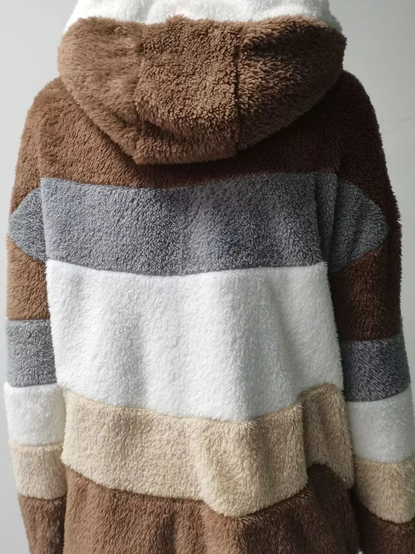 Soft plush faux fur zip jacket with drawstring hood and pockets.