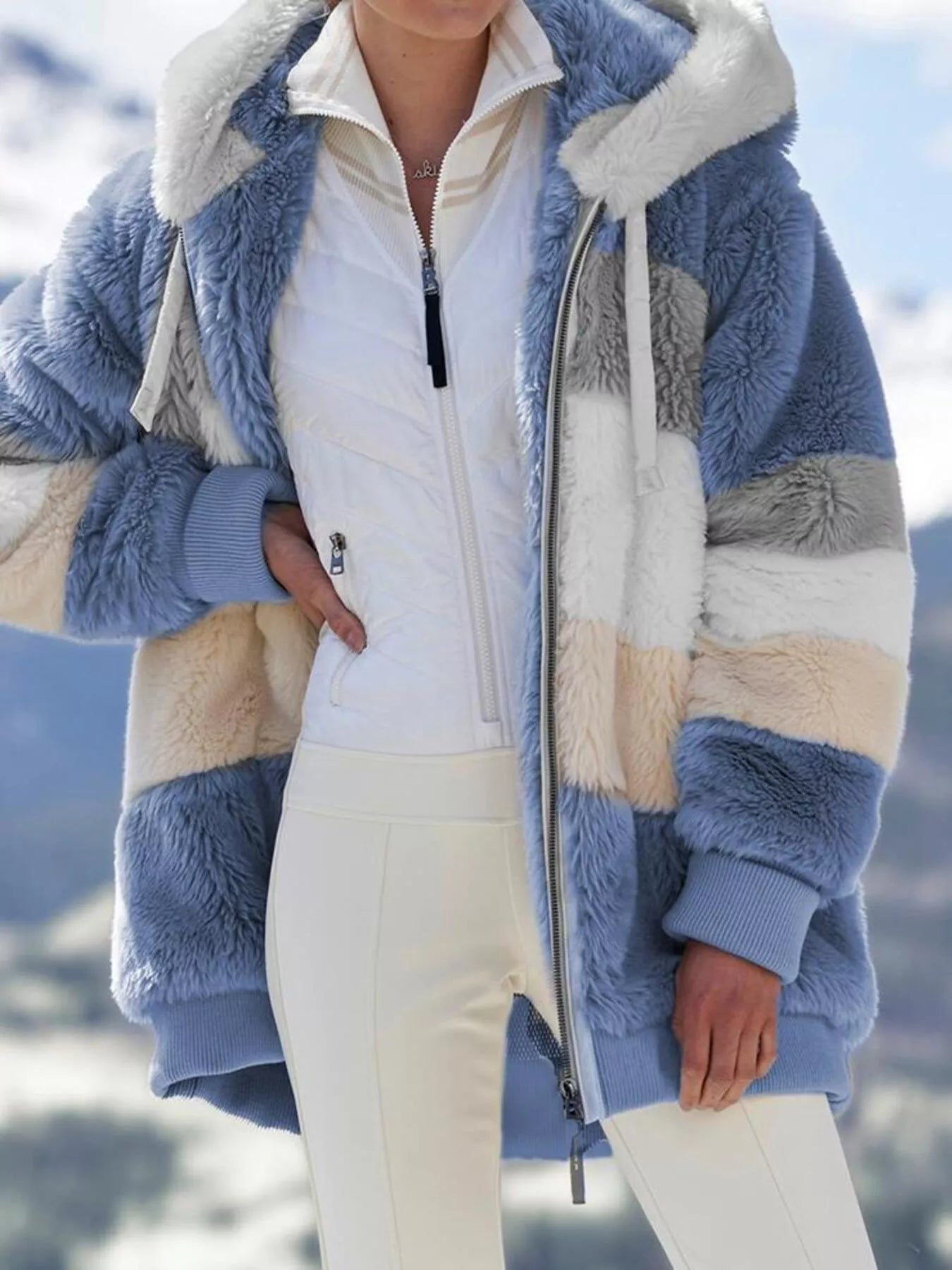 Soft plush faux fur zip jacket with drawstring hood and pockets.