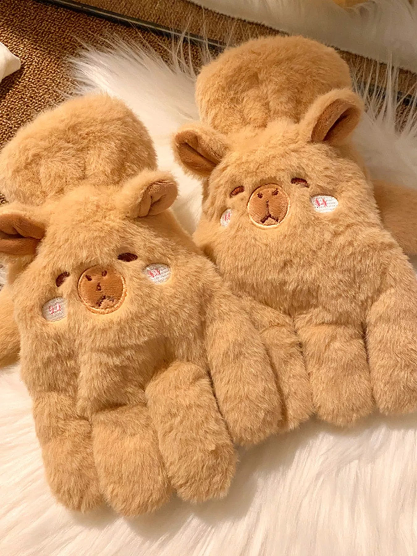 Pair of fluffy lamb-shaped plush gloves in soft neutral tones, cozy and cute winter handwear
