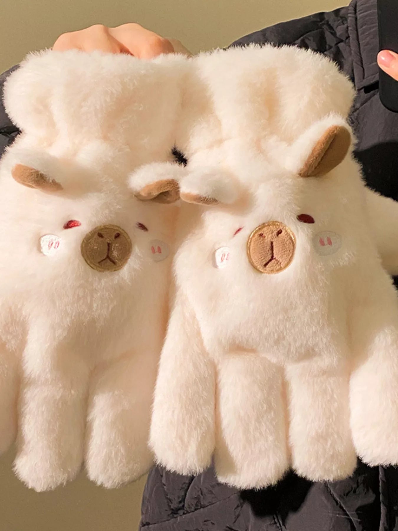 Pair of fluffy lamb-shaped plush gloves in soft neutral tones, cozy and cute winter handwear