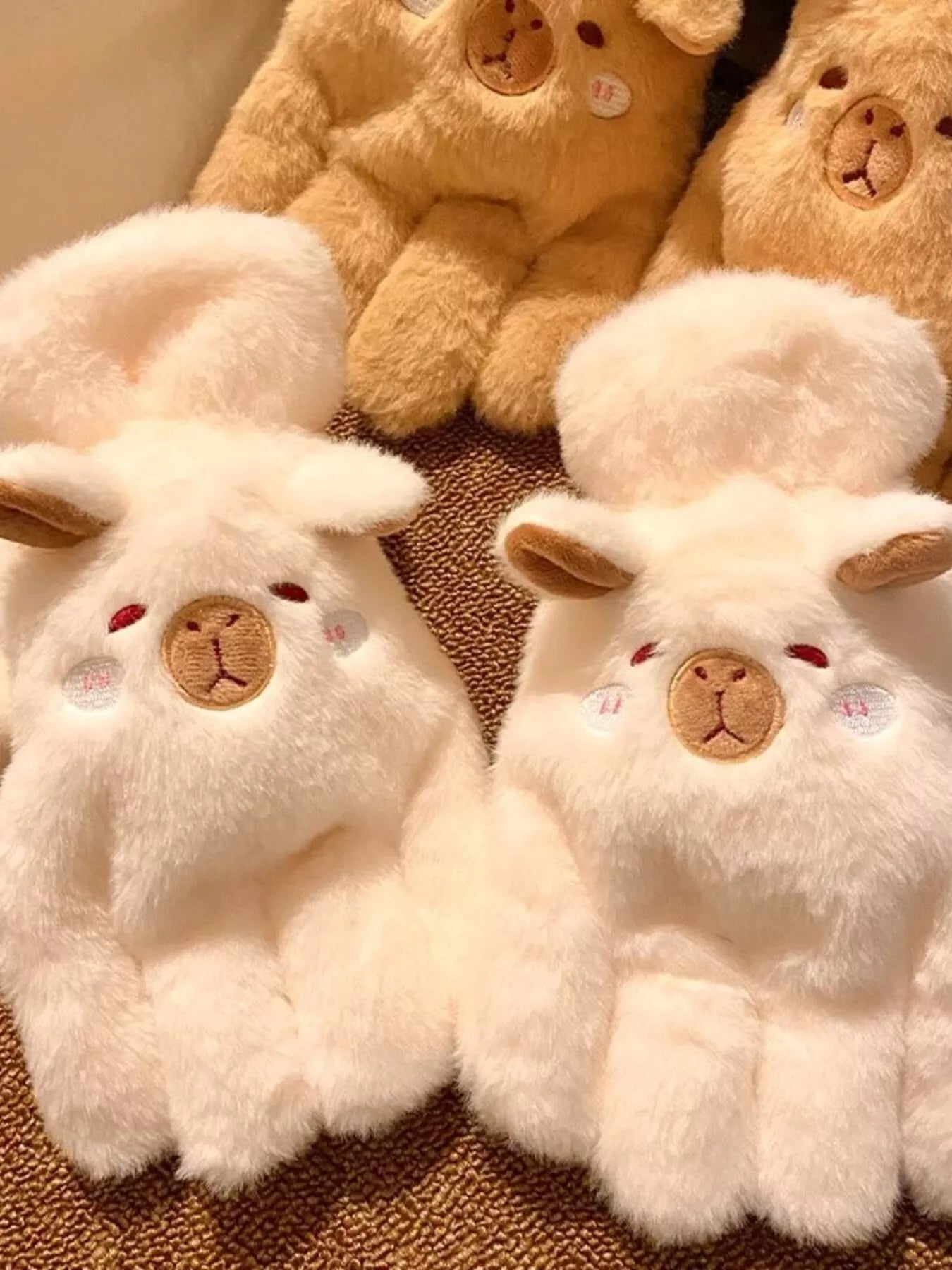Pair of fluffy lamb-shaped plush gloves in soft neutral tones, cozy and cute winter handwear