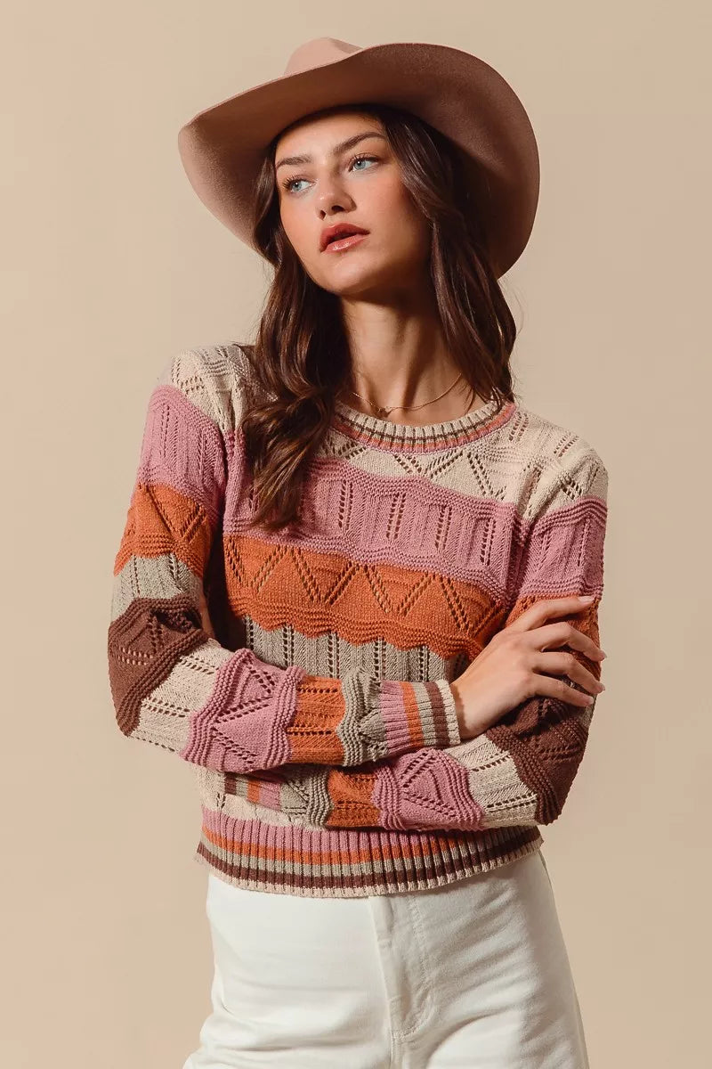 Woman wearing multicolor wavy stripe sweater in Neapolitan-inspired shades