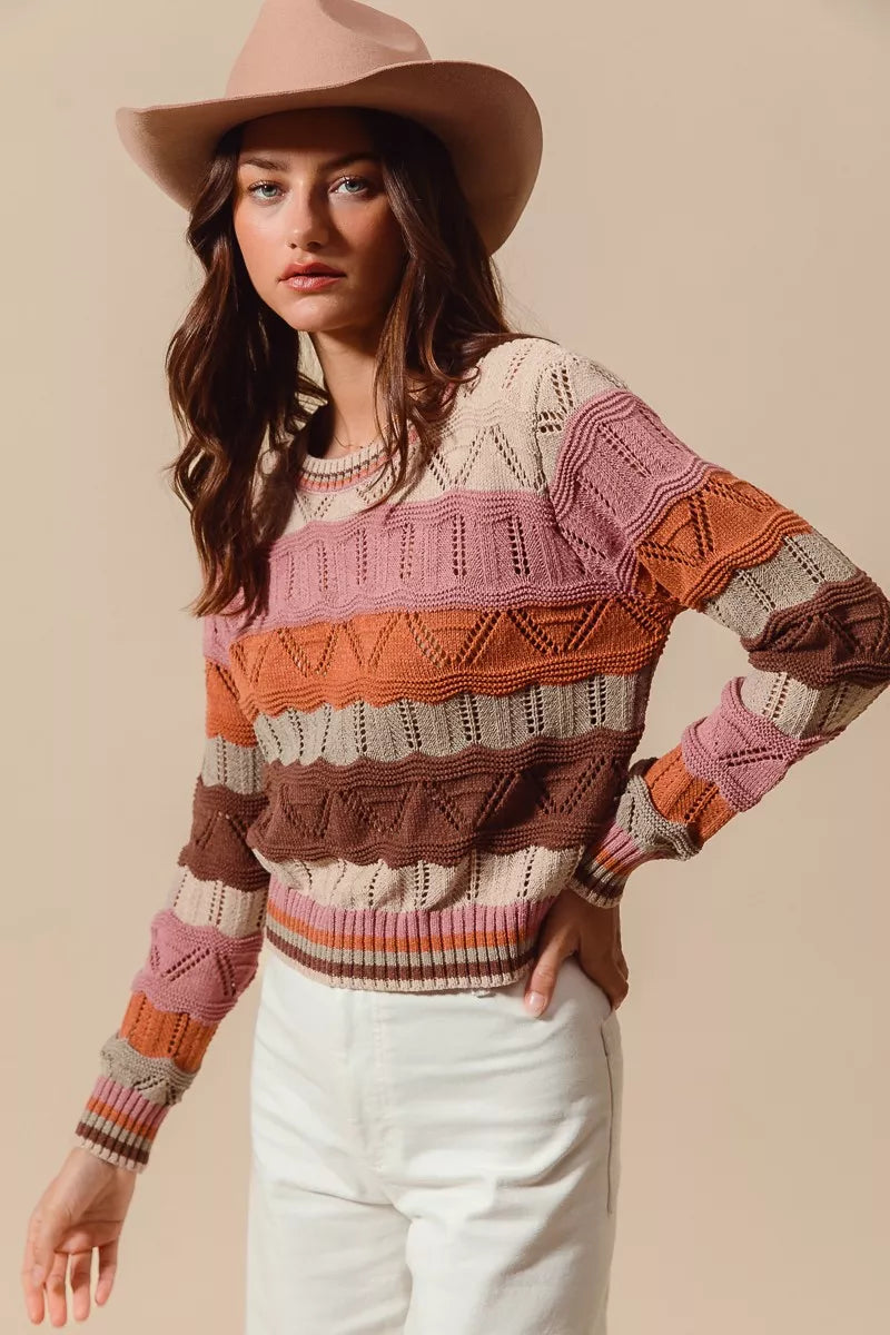 Woman wearing multicolor wavy stripe sweater in Neapolitan-inspired shades