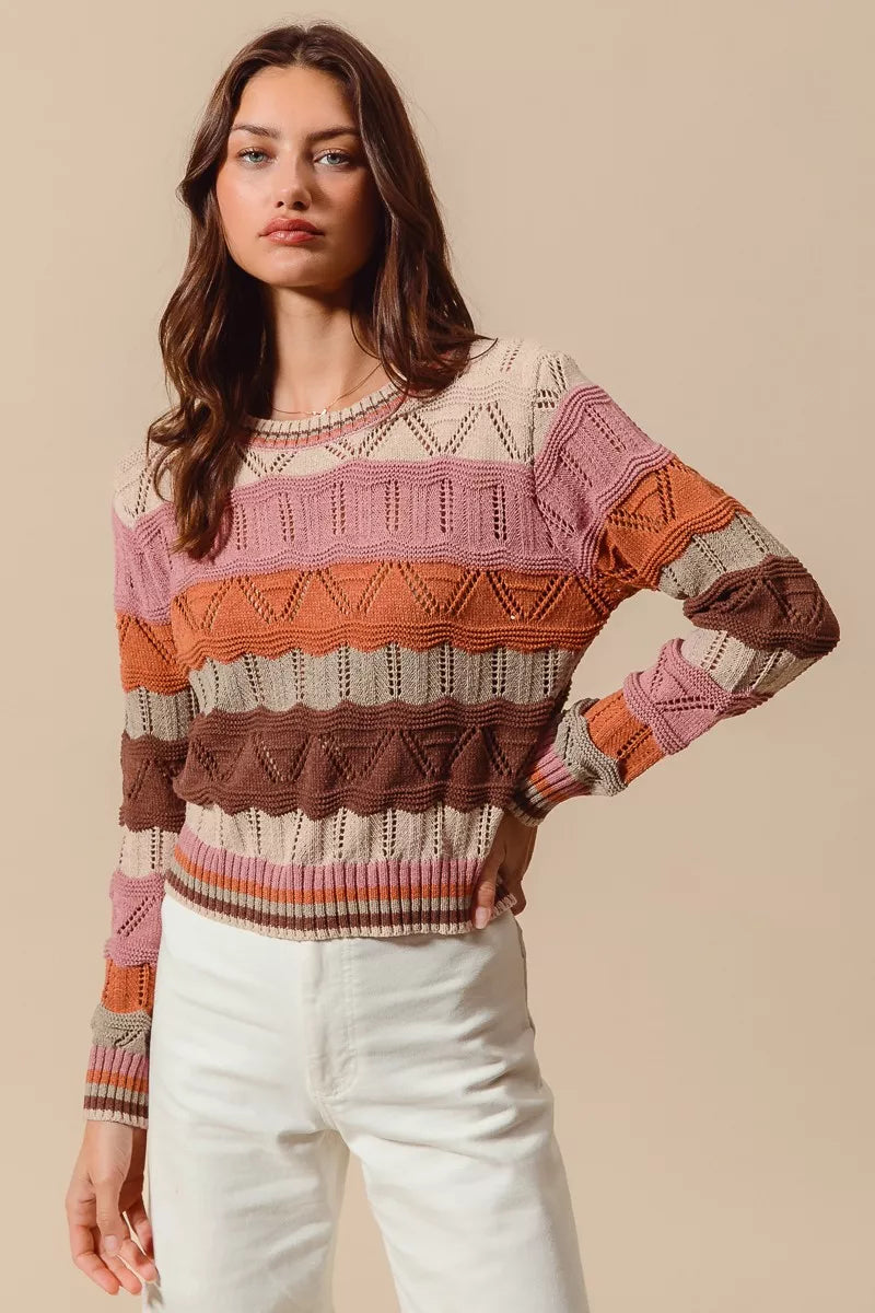 Woman wearing multicolor wavy stripe sweater in Neapolitan-inspired shades