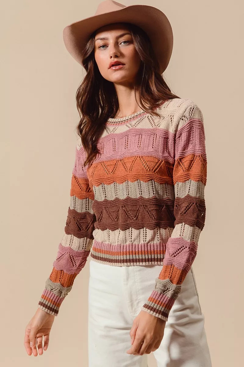 Woman wearing multicolor wavy stripe sweater in Neapolitan-inspired shades