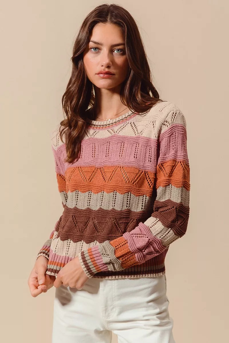 Woman wearing multicolor wavy stripe sweater in Neapolitan-inspired shades