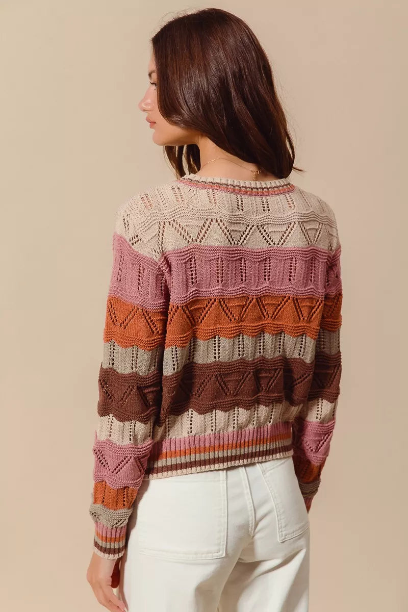 Woman wearing multicolor wavy stripe sweater in Neapolitan-inspired shades