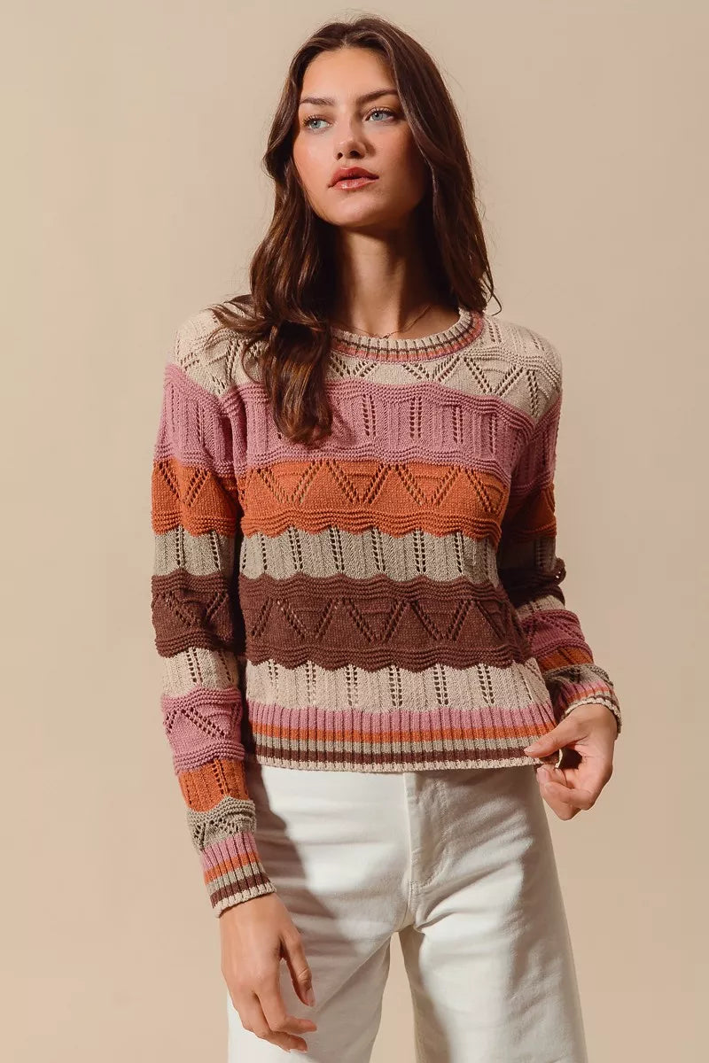 Woman wearing multicolor wavy stripe sweater in Neapolitan-inspired shades