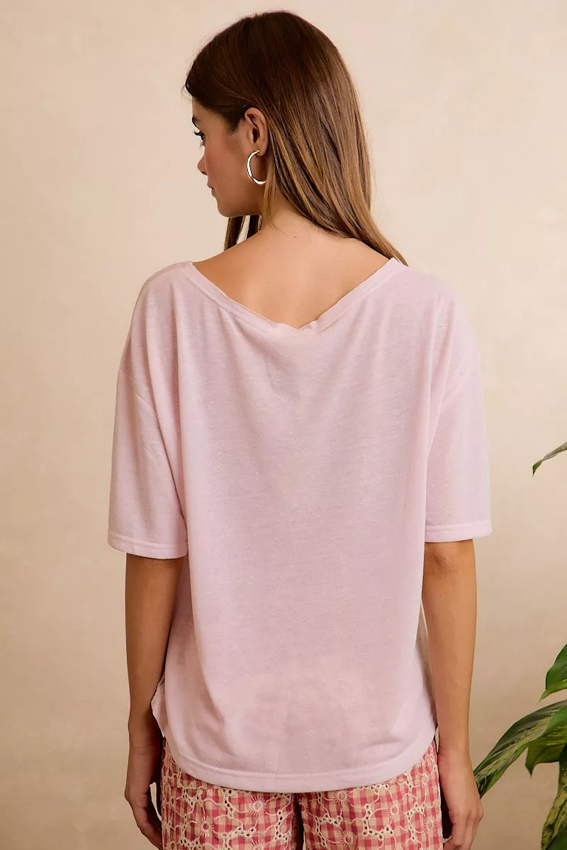 Lightweight oversized short sleeve tee with a sheer finish, front pocket detail, and relaxed slightly stretchy fit styled with printed pants.
