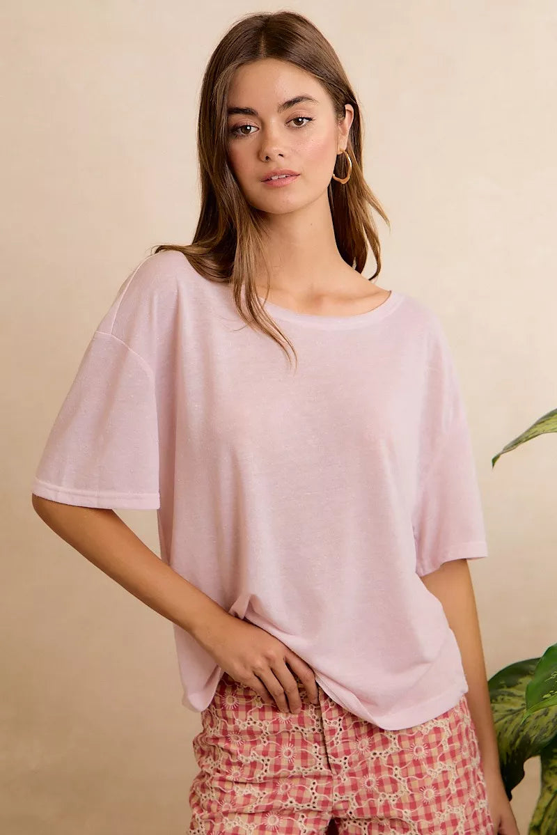 Lightweight oversized short sleeve tee with a sheer finish, front pocket detail, and relaxed slightly stretchy fit styled with printed pants.