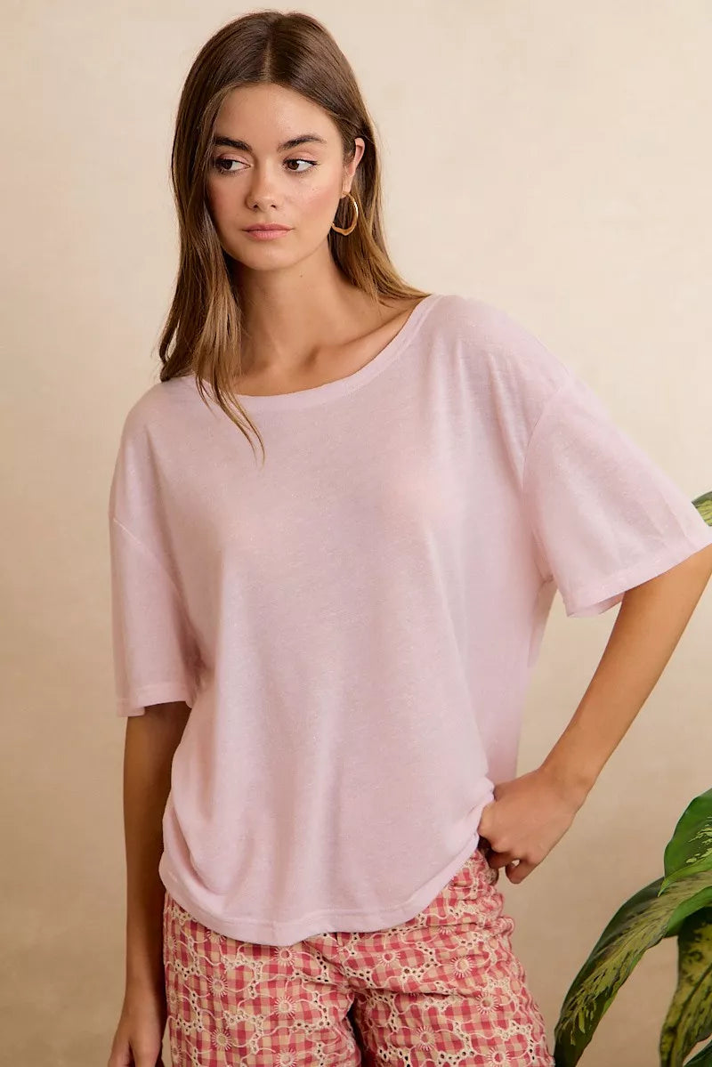 Lightweight oversized short sleeve tee with a sheer finish, front pocket detail, and relaxed slightly stretchy fit styled with printed pants.