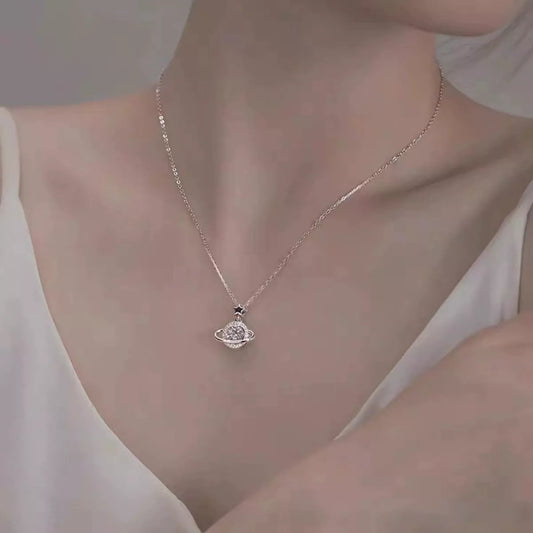Sterling silver Saturn-inspired pendant necklace with 1ct moissanite center stone, star accent, and matching jewelry box.