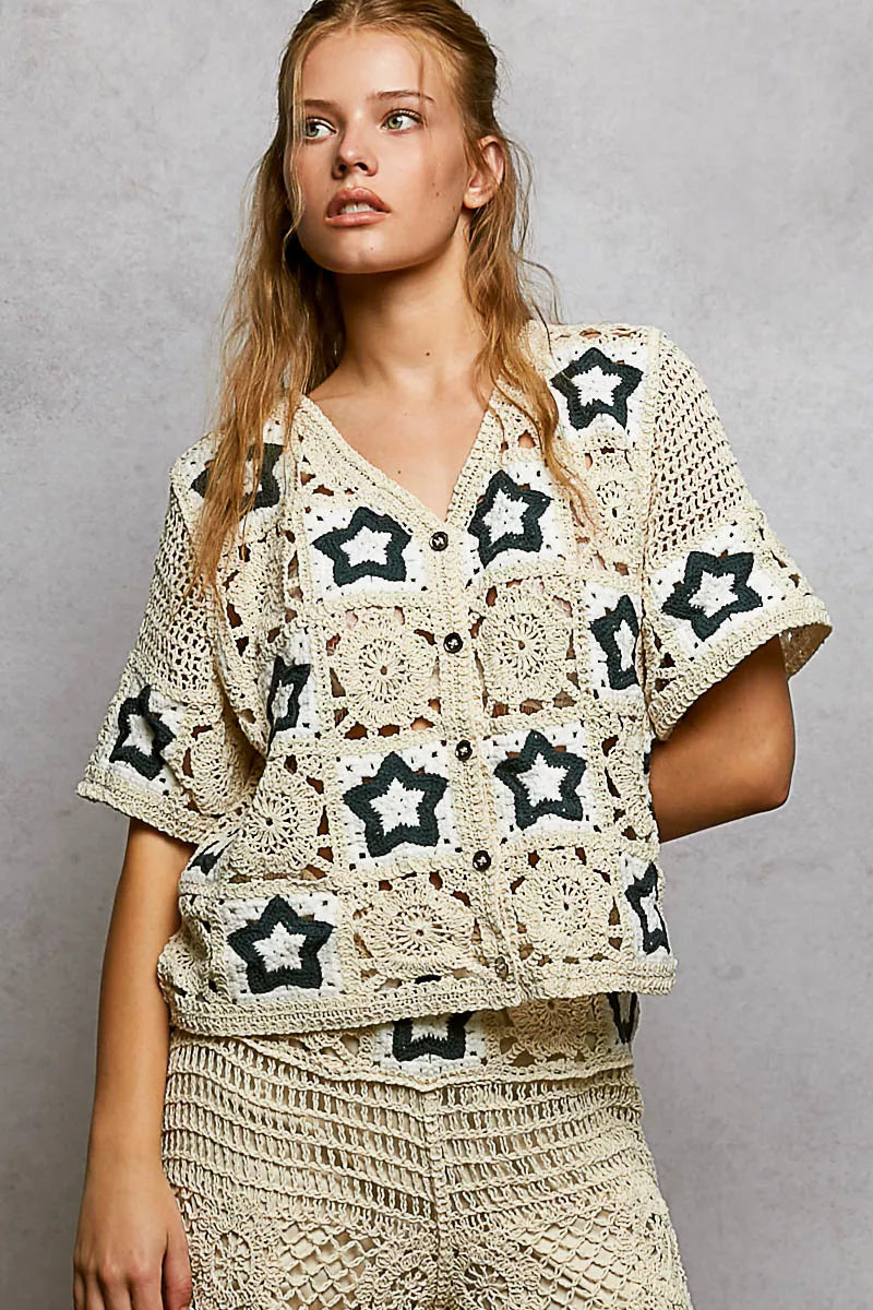 Cream crochet button-front cardigan featuring openwork detailing and contrast star motifs in a relaxed boho silhouette