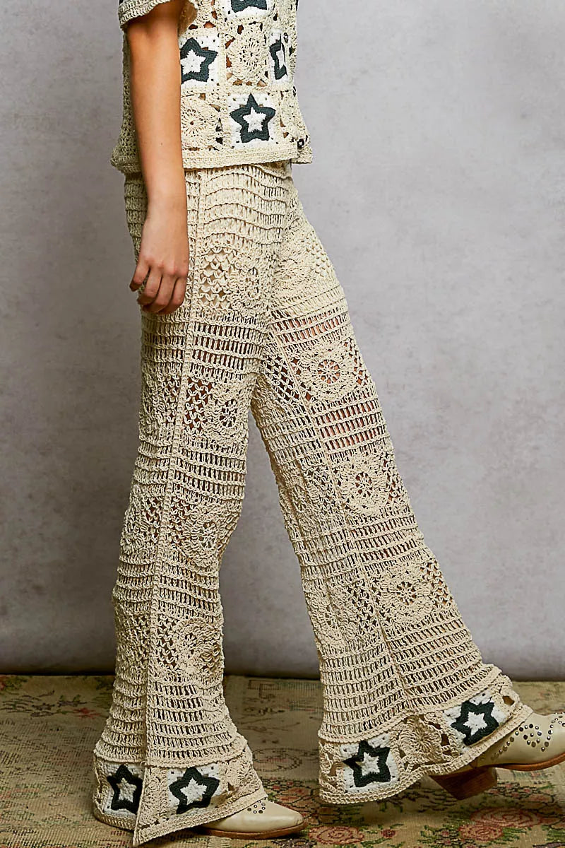 Cream crochet pants with intricate openwork patterns and star details