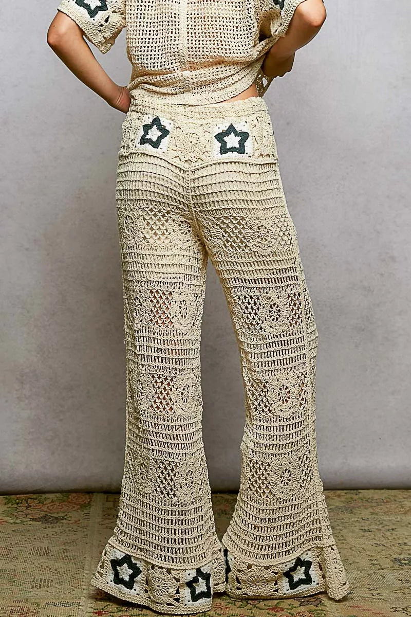 Cream crochet pants with intricate openwork patterns and star details