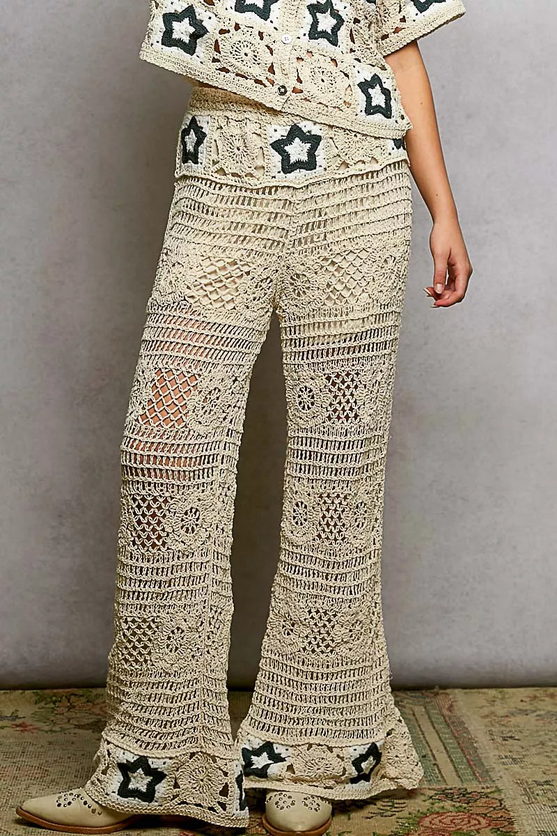 Cream crochet pants with intricate openwork patterns and star details