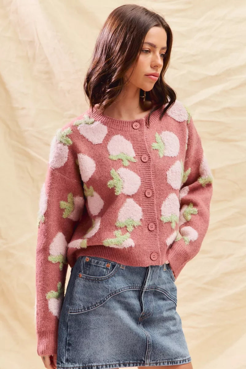 Model wearing pink strawberry button cardigan, cottagecore knit outfit for fall.