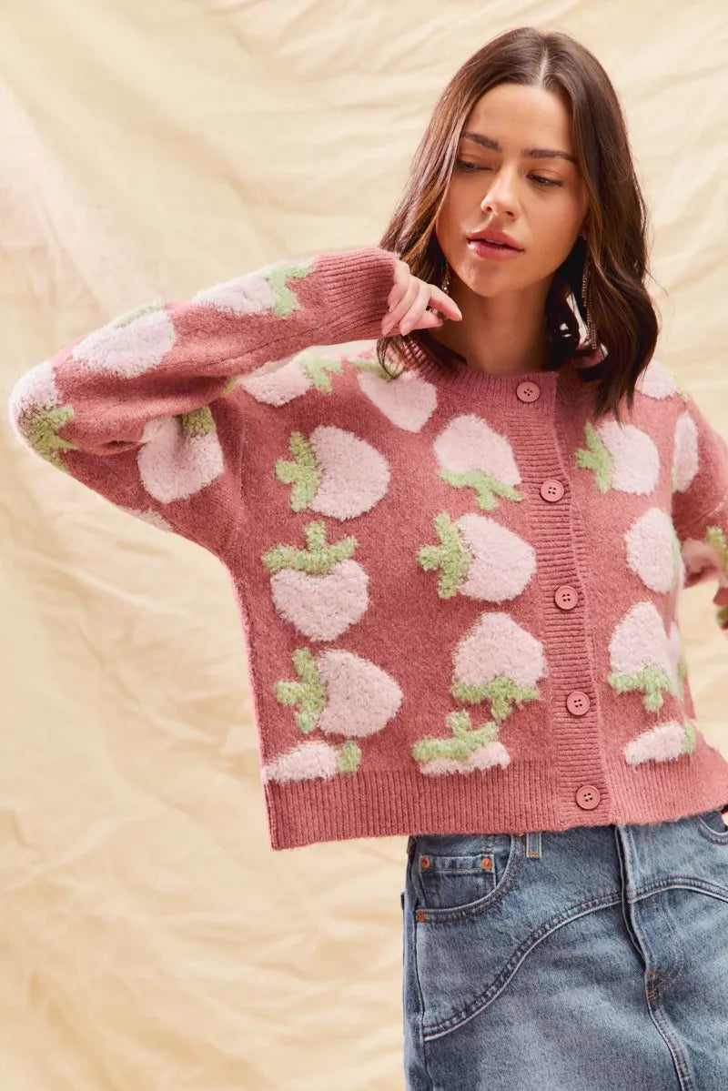 Model wearing pink strawberry button cardigan, cottagecore knit outfit for fall.