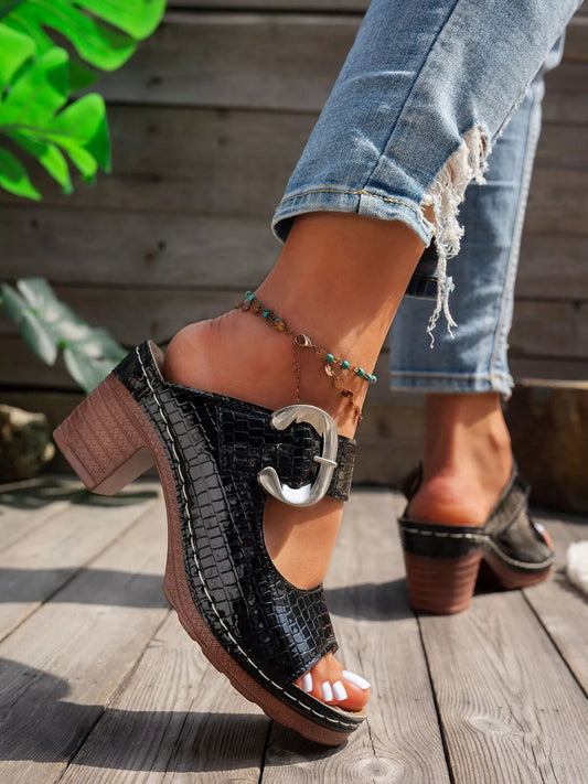 Black crocodile-textured open toe block heel sandals with bold buckle.