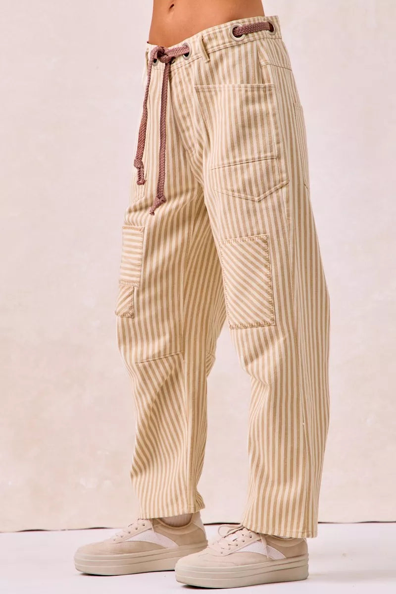 Beige and cream striped barrel leg pants with drawstring waist and patch pockets
