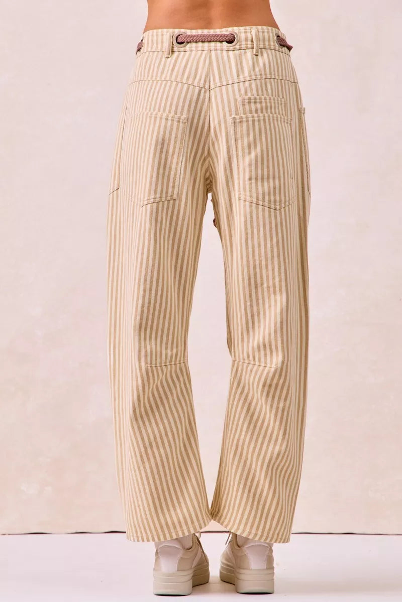 Beige and cream striped barrel leg pants with drawstring waist and patch pockets
