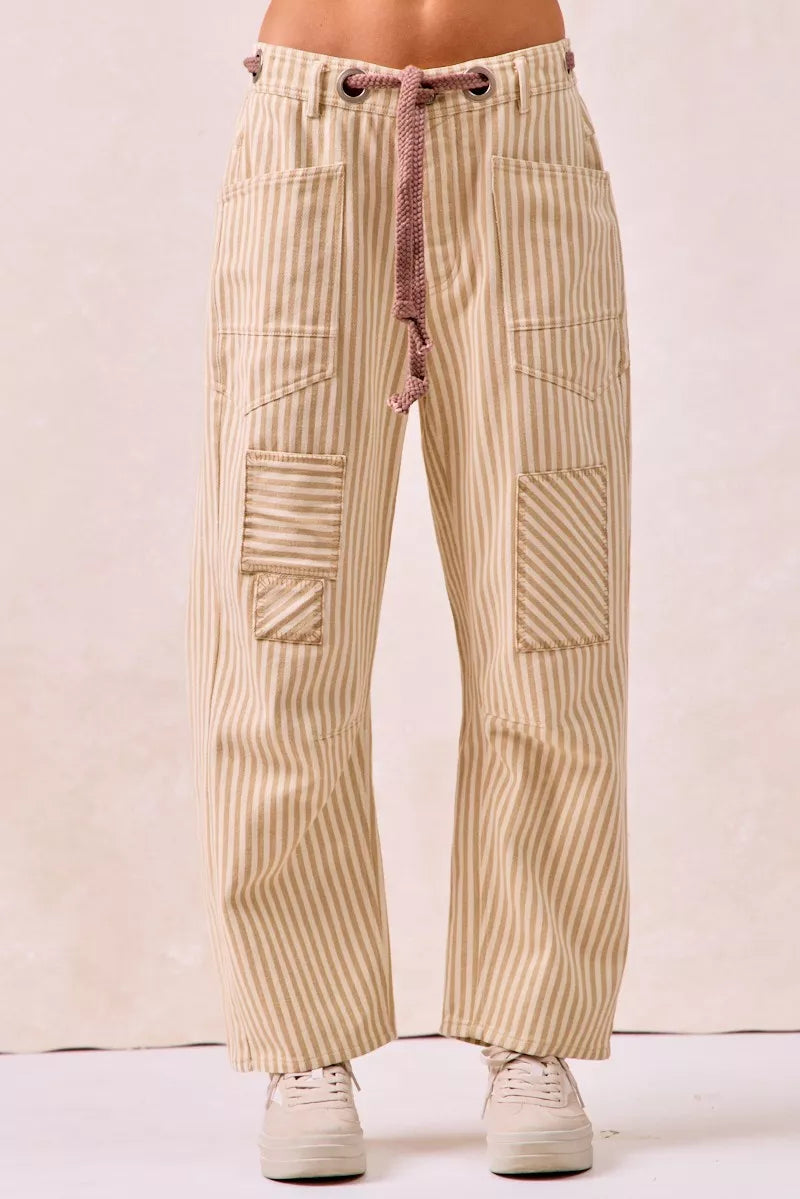 Beige and cream striped barrel leg pants with drawstring waist and patch pockets