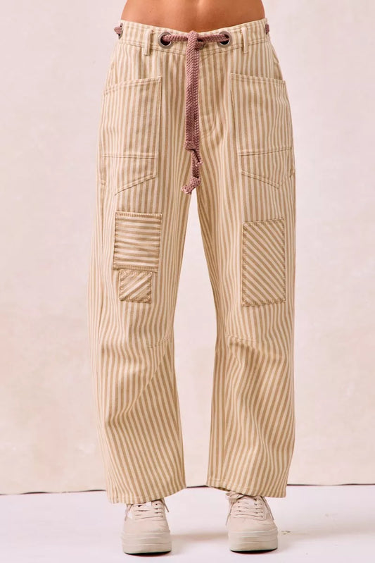 Beige and cream striped barrel leg pants with drawstring waist and patch pockets