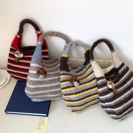 Small striped knit tote bag with mushroom charm detail and textured handle.