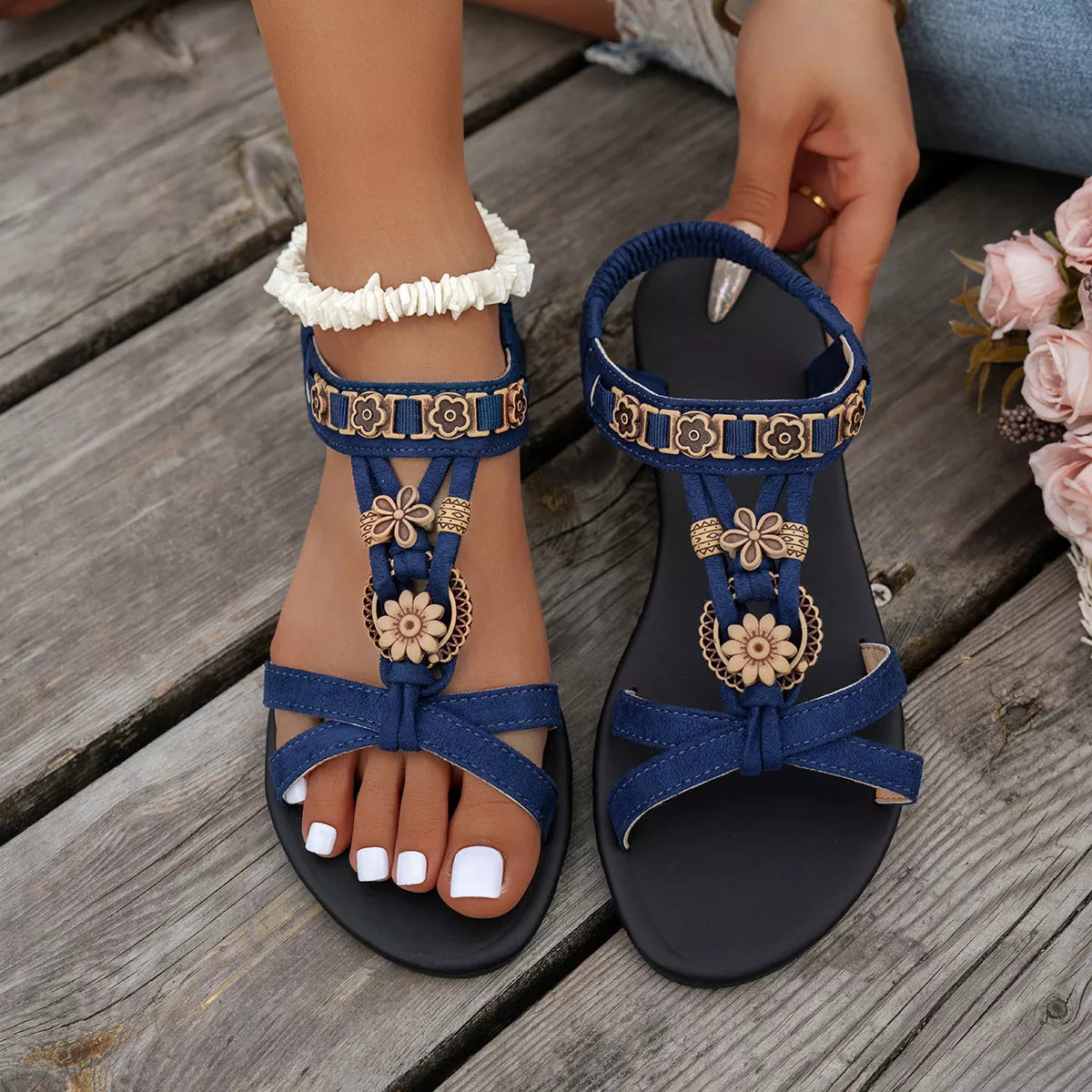Blue low heel T-strap ankle sandals with buckle closure.