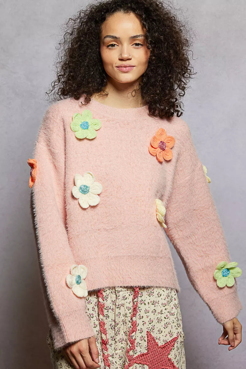 Model wearing the Sugar Blossom Mohair Sweater — a soft pink fuzzy knit with colorful 3D floral appliqués, paired with floral skirt.