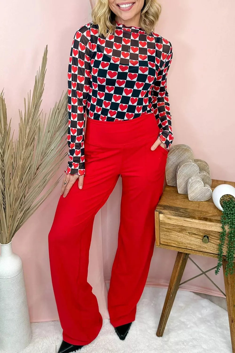 Bright pink and red checkered sheer mesh long sleeve top with a slightly stretchy fit styled with light denim jeans.
