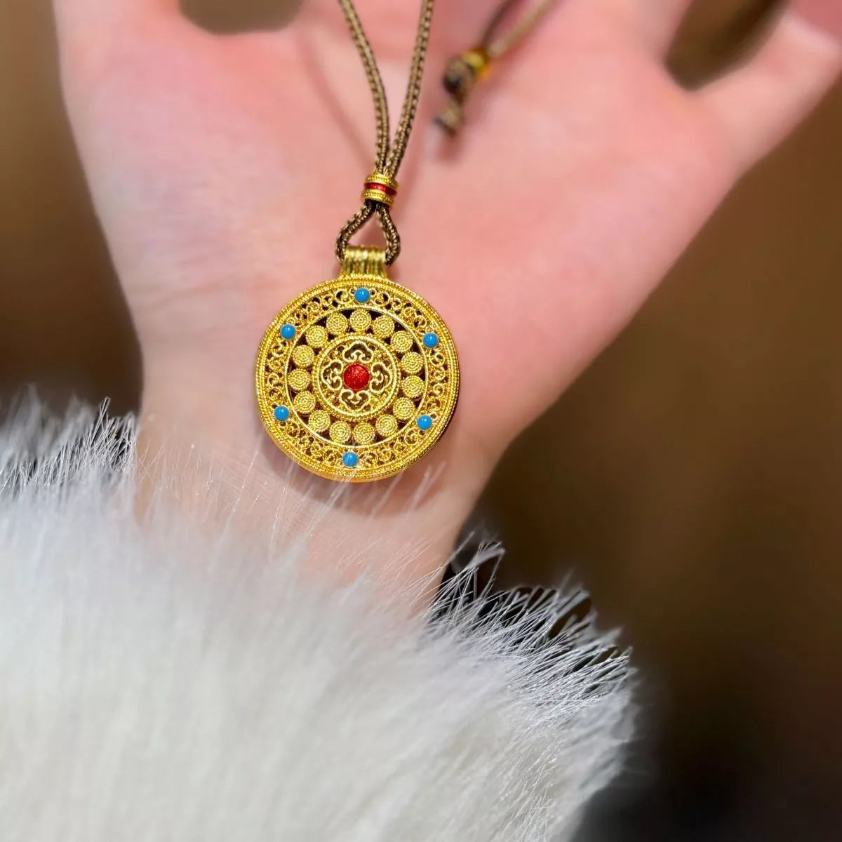 18K gold-plated medallion necklace with ornate circular design, zircon accents, and colorful red and turquoise details.