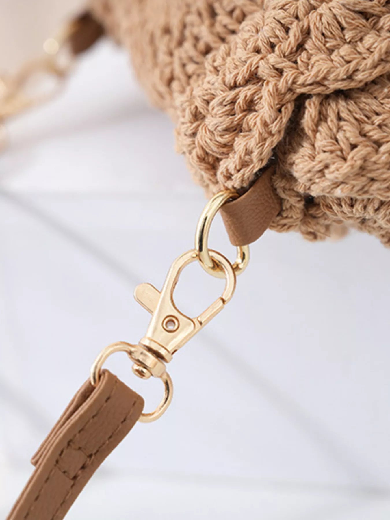 Small round crochet crossbody bag in natural beige cotton thread with scalloped edges and a flap closure.