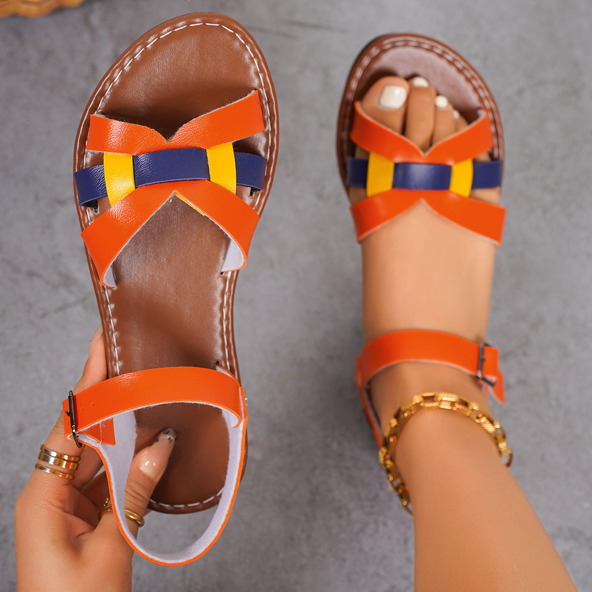 Flat multi-strap sandals with ankle buckle closure and woven-inspired design