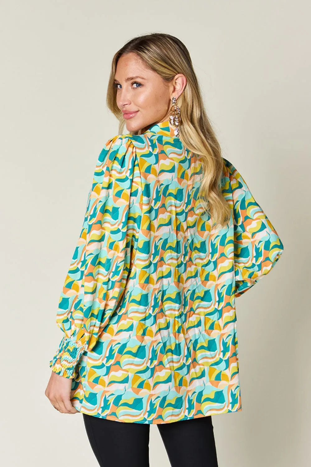 Abstract print blouse with smocked cuffs and long sleeves