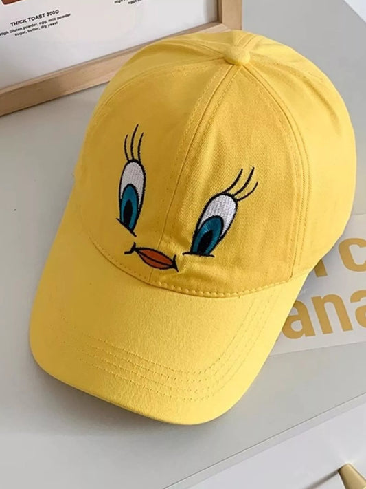 Bright yellow cotton baseball cap with an embroidered bird face design on the front.