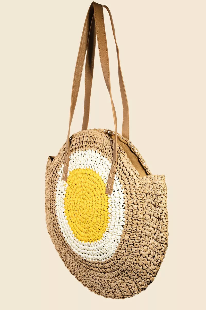 Round straw tote bag with braided design and happy face motif.