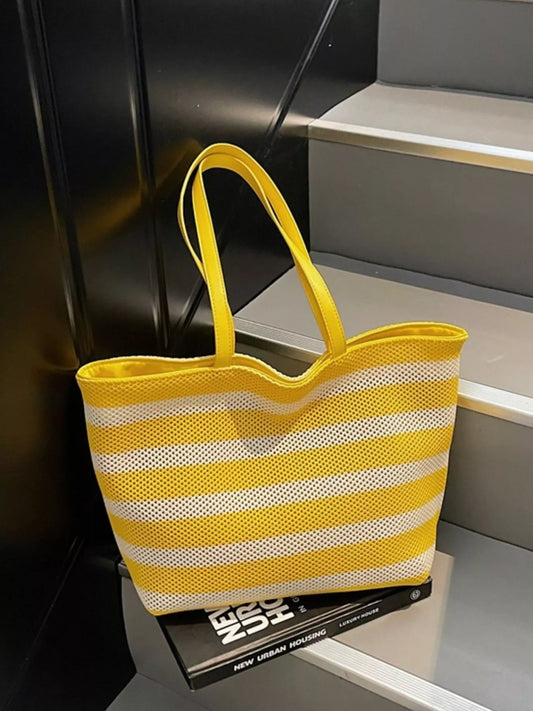 Large yellow and white striped mesh tote bag with shoulder straps, lightweight polyester material, and casual everyday styling.