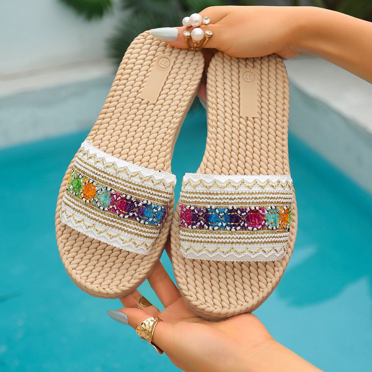 Flat woven slide sandals with colorful embroidered strap