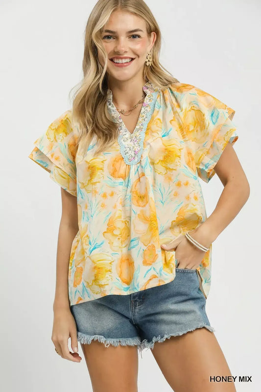 pastel floral ruffle sleeve blouse with yellow and blue watercolor flowers in a romantic boho style