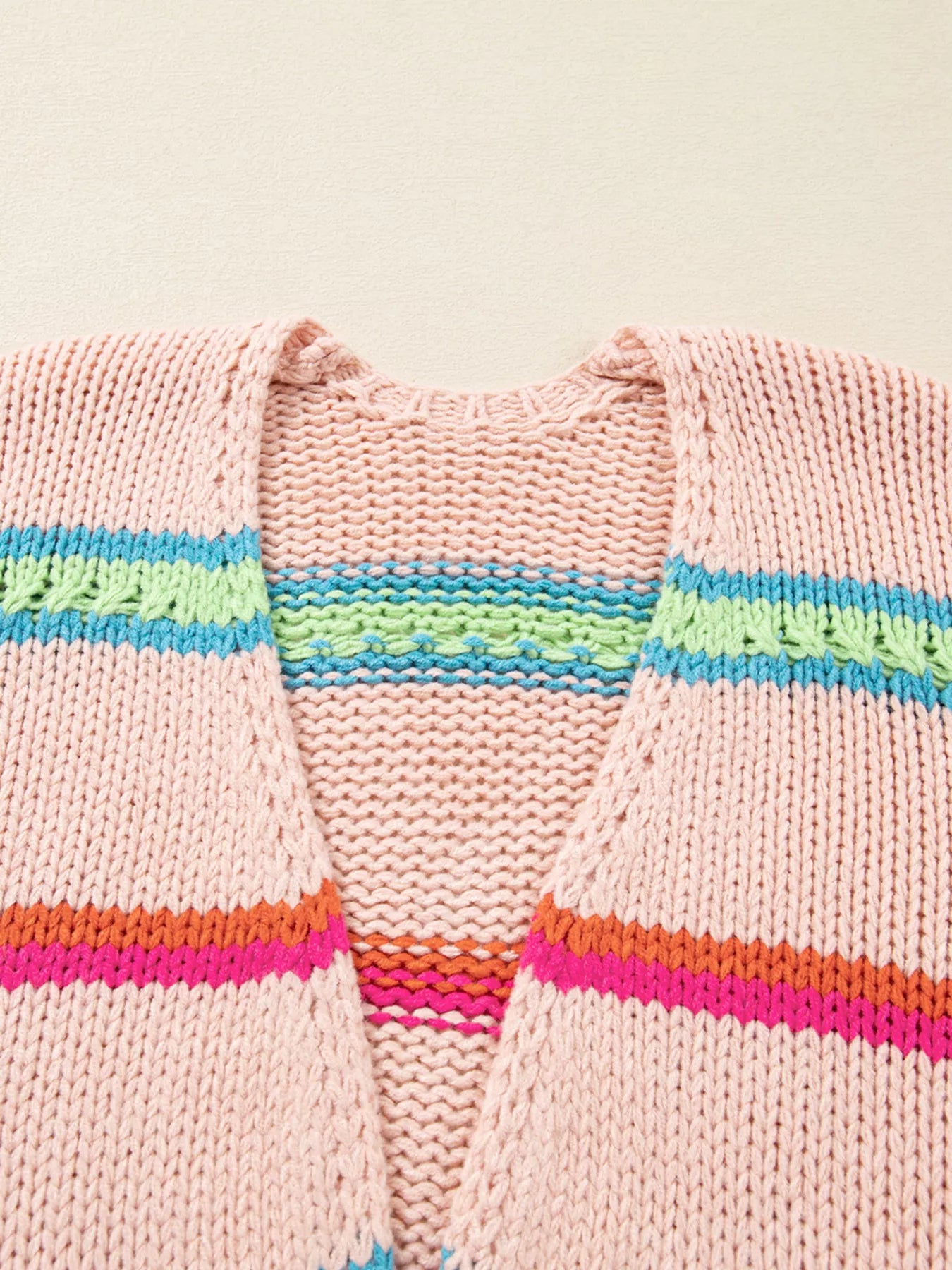 Multicolor striped knit cardigan with ribbed cuffs styled over a white tank and jeans
